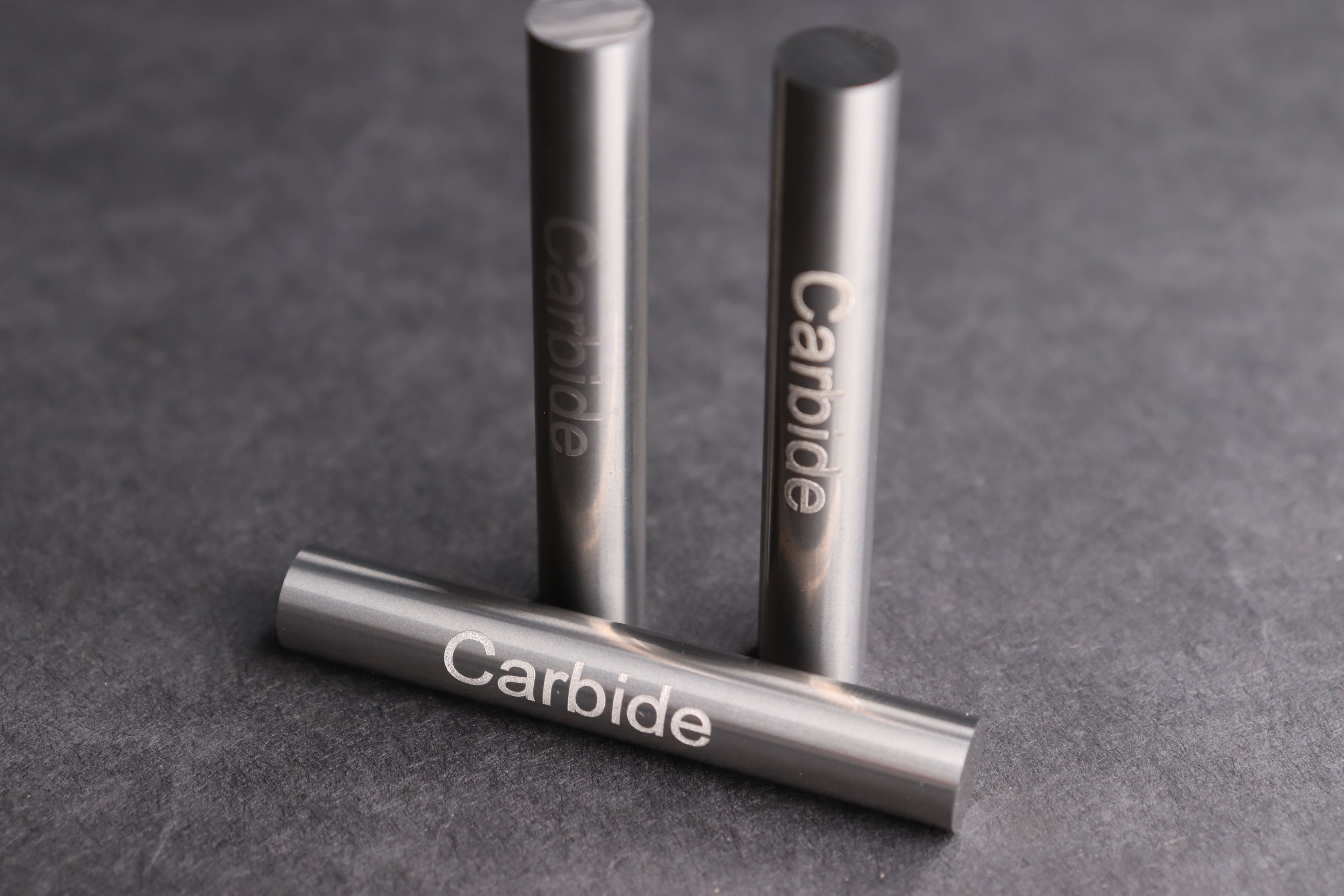 Image of three pieces of tungsten carbide engraved with the word 'Carbide'.