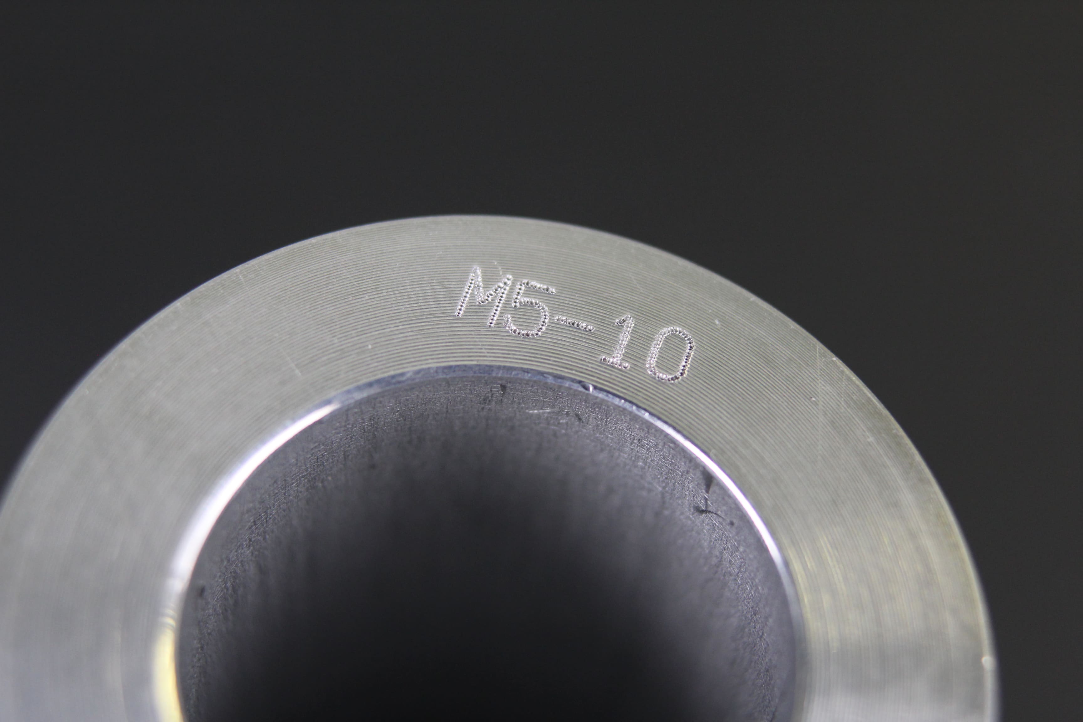 Image of an end bar engraved with text and numbers reading 'M5-10'.