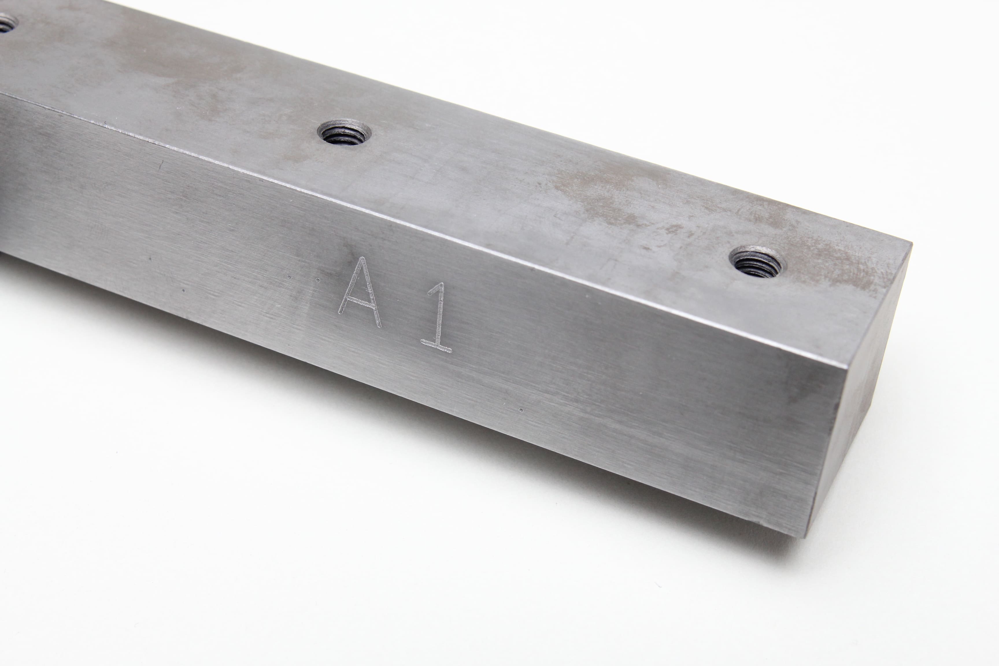 Image of hardened steel material engraved with text and numbers reading 'A1'.