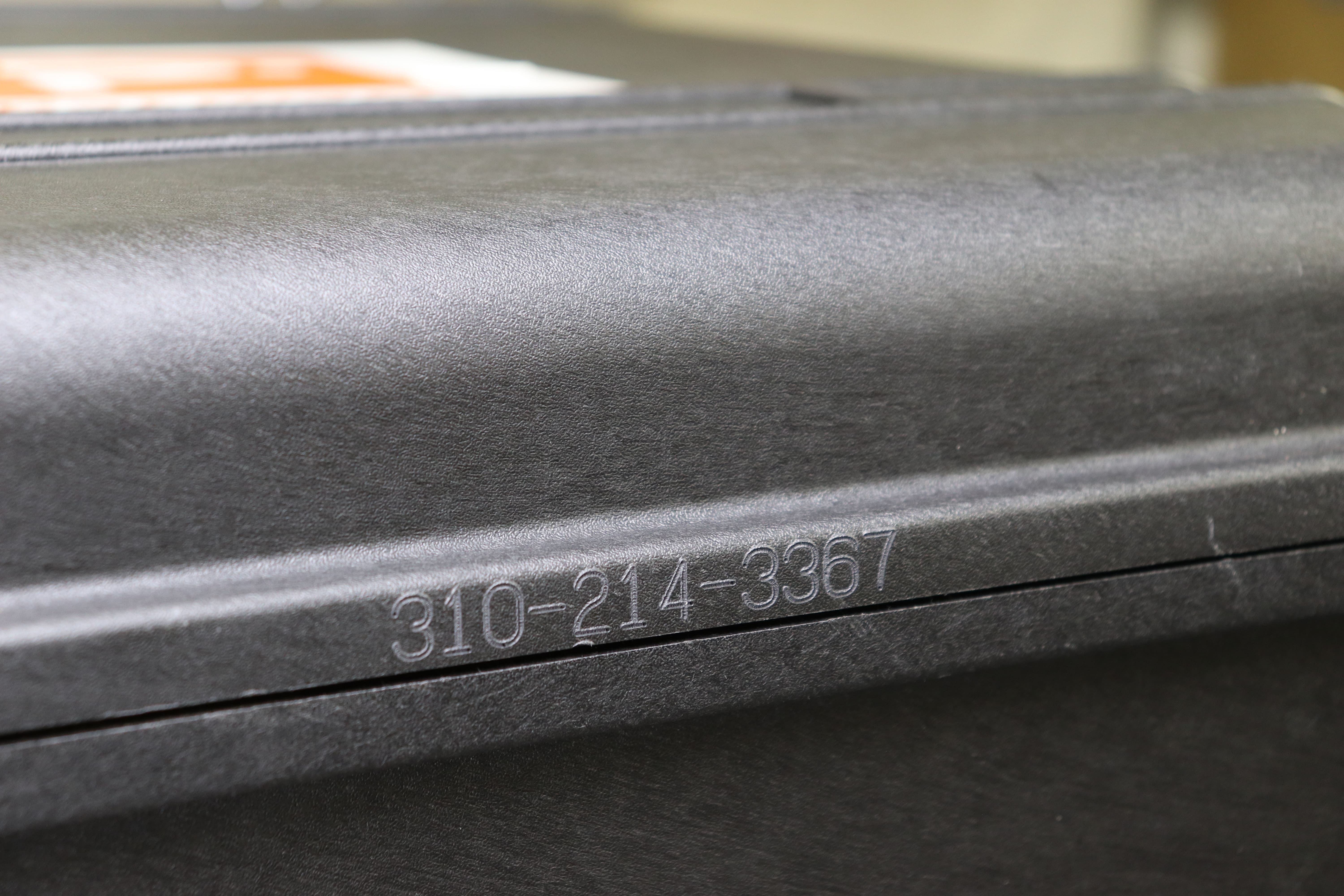 Image of the thin edge of the carrying case engraved with the product number '310-214-3367'.