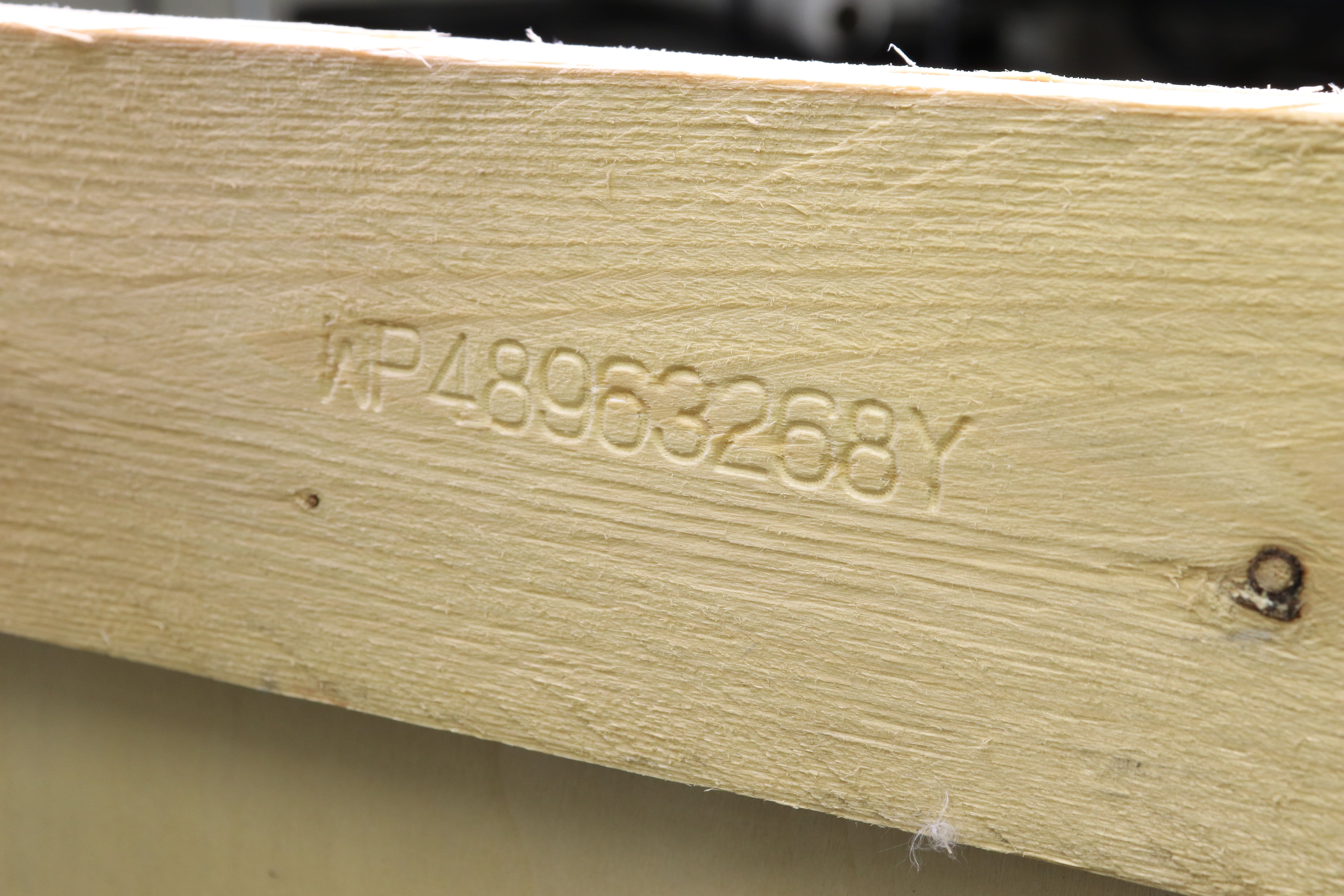 Image of wood engraved with text and numbers 'WP48963268Y'.