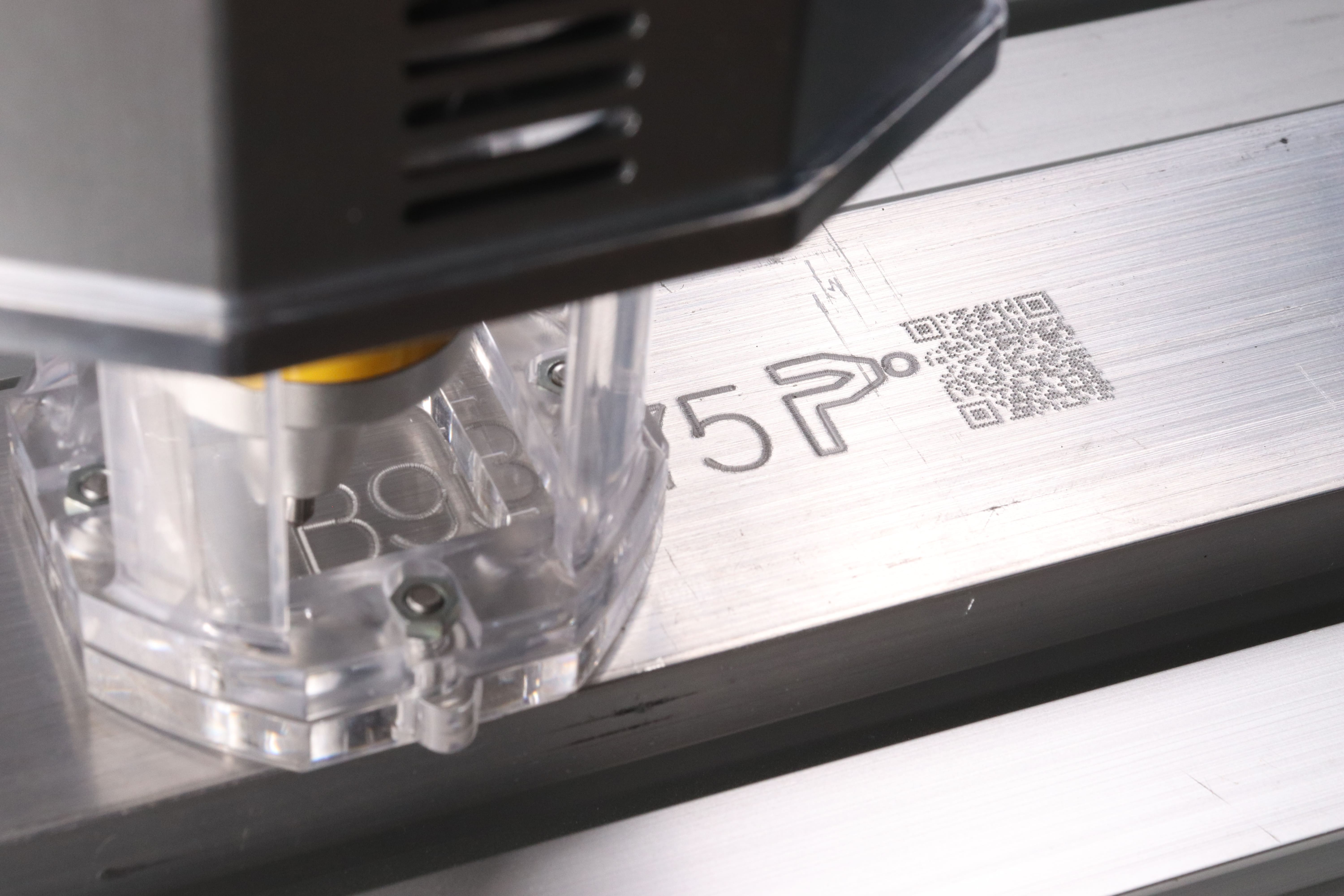 Image of text and QR code engraved by the Patmark robot from the Patmark series.