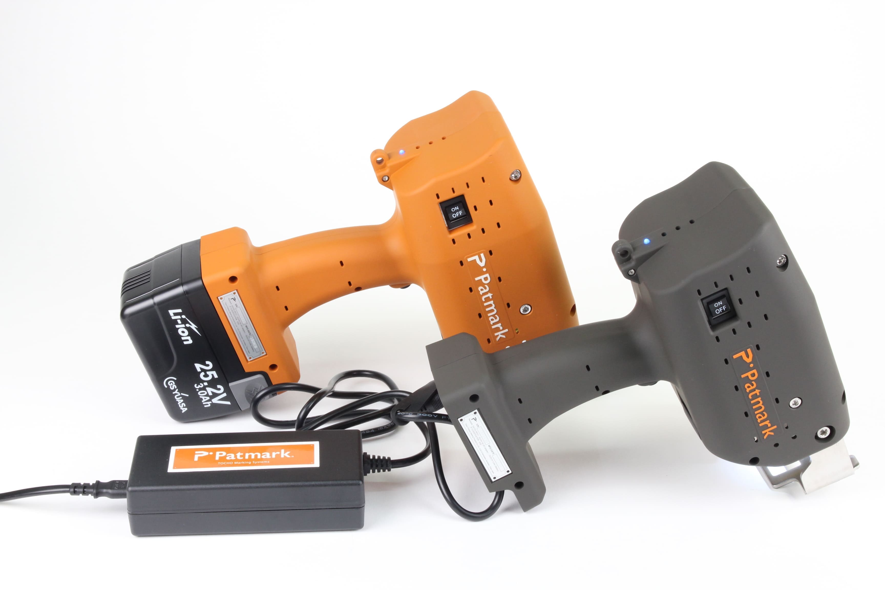 Image of two Patmark Series units, one in orange and one in black, placed side by side. The black one is equipped with an adapter.