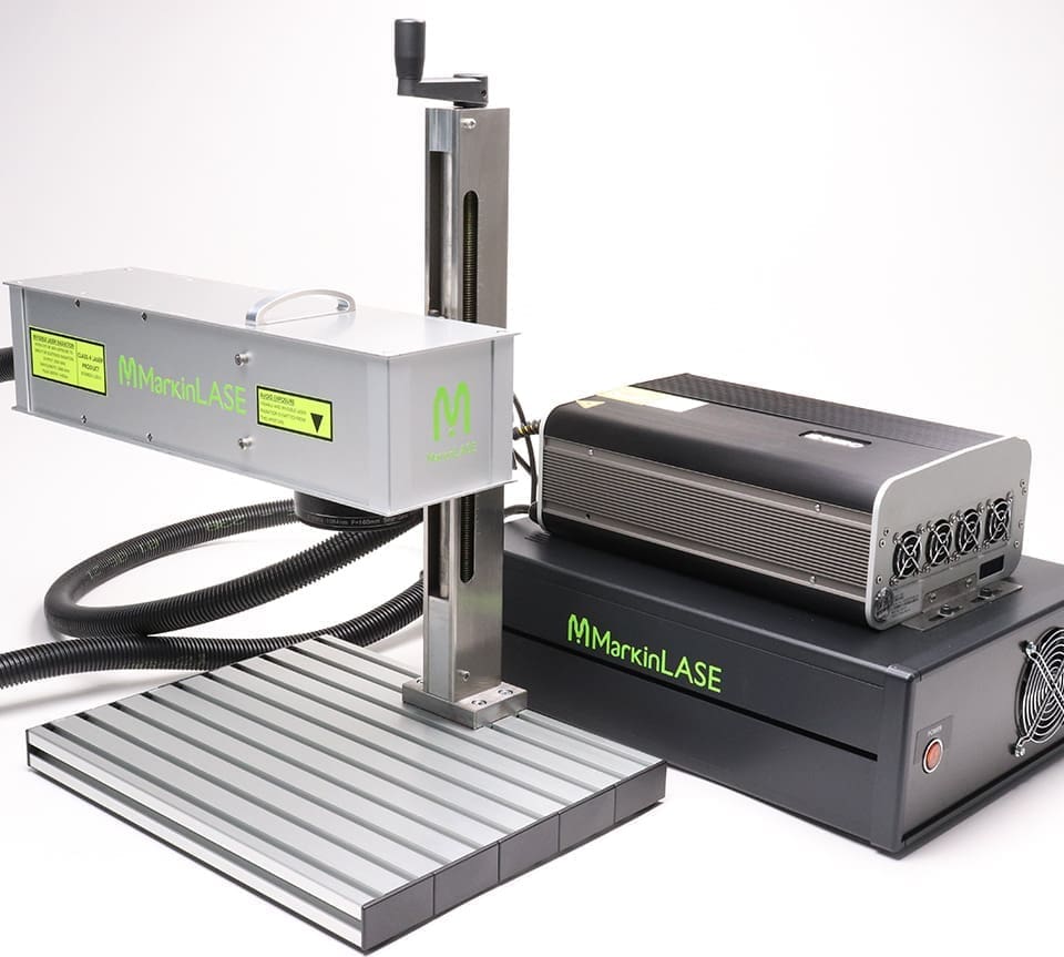 ML-B-20-Class4. Flexible Fiber Laser Marker MarkinLASE is placed side by side on a white background. The Laser Head is simply attached to the tool post. It is labeled 'MMarkinLASE'.
