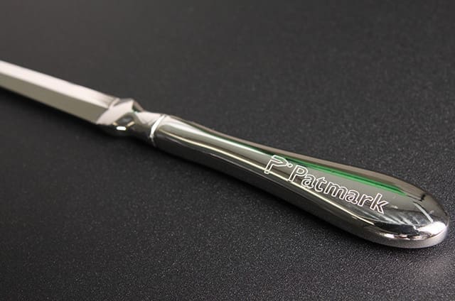 A silver knife with the words 'P.Patmart' engraved on the handle.